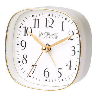 Left facing image of a retro style La Crosse Clock Co table top alarm clock with white dial black numbers and gold accents.