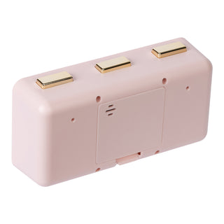 Angled back image of the 636-379P Daily Flip Tabletop Clock with Calendar – Pink Blush, showing the battery compartment with the cover in place, and the three brass buttons to operate the calendar and the alarm.